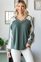 Front close-up of the 7th Ray Color Block V-Neck Knit Top featuring lace and stripe contrast sleeves with a relaxed fit.