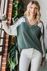 Lifestyle shot of the 7th Ray Color Block V-Neck Knit Top worn with white jeans, styled for casual boho fashion with lace and stripe contrast details.