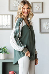 Side close-up of the 7th Ray Color Block V-Neck Knit Top highlighting lace accents, stripe contrast sleeves, and curved hem.