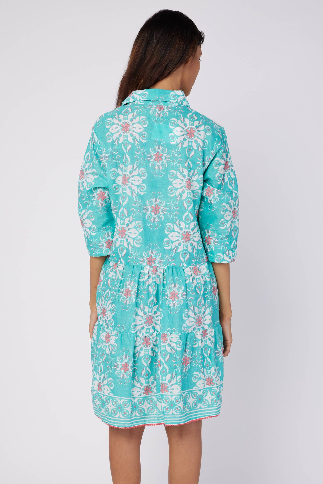 Back view of the Alcee Blue and White Resort Shirt Dress by ModaPosa, showing the flowing cotton fabric and intricate majolica motif.