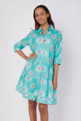 Front view of the Alcee Blue and White Resort Shirt Dress by ModaPosa, featuring a Mediterranean-inspired majolica motif and pom pom trim.