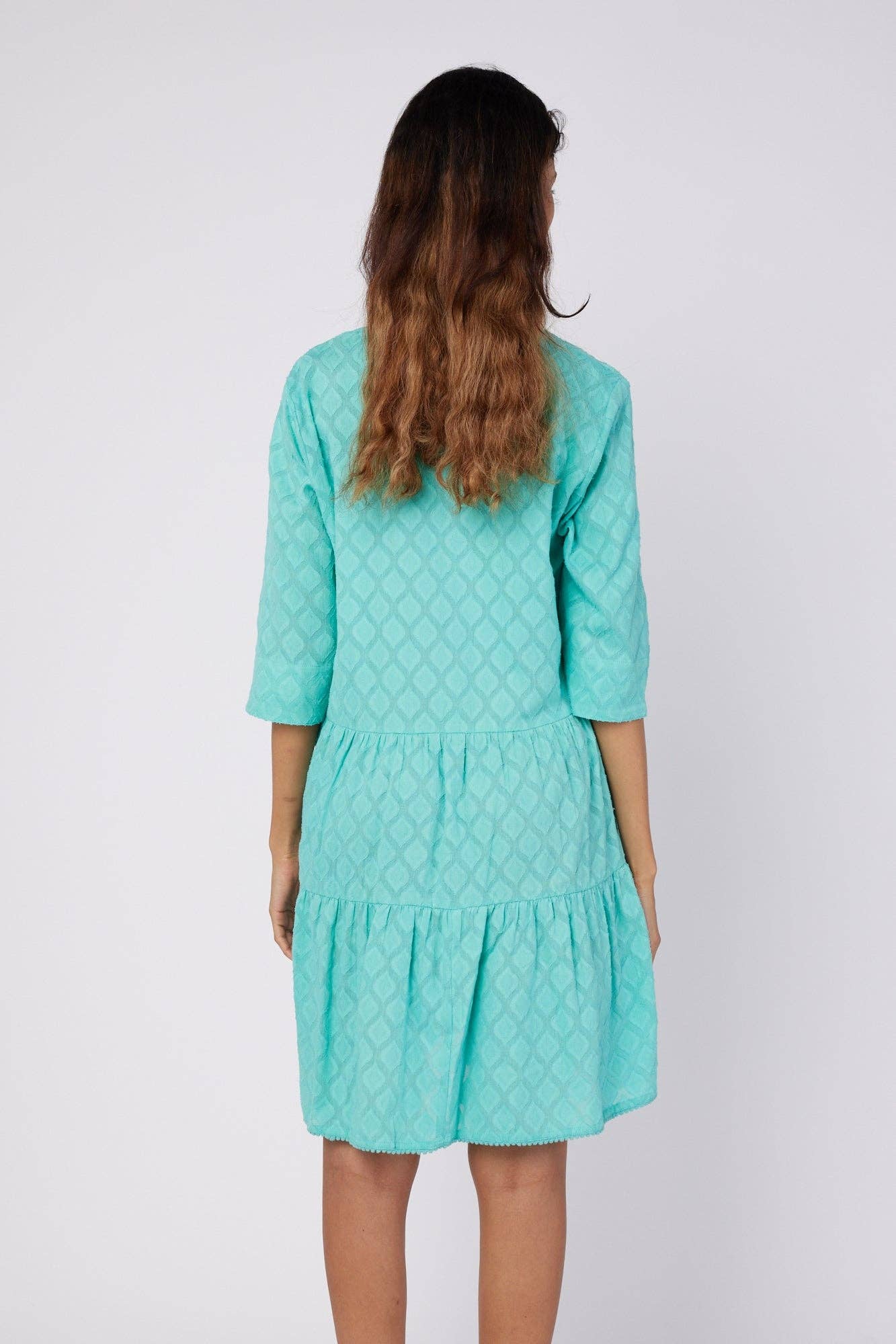 Back view of the Moda Posa Alcee Turquoise Shirt Dress showcasing its tiered design and soft turquoise fabric with subtle patterns.