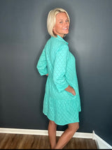 Model showing the side view of the Moda Posa Alcee Turquoise Shirt Dress with hidden side pockets, perfect for effortless, chic summer style.