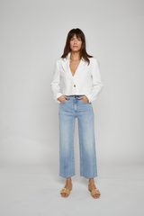 Front view of model wearing Oliver Logan Aberdeen High-Rise Light Indigo Jeans, featuring a wide-leg cropped fit and raw hem.