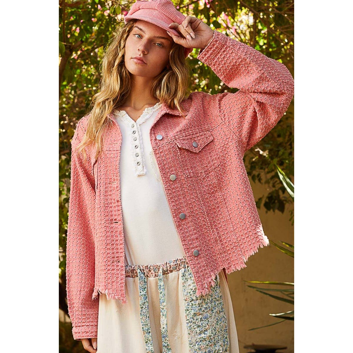 Model wearing the Pol Clothing Vintage Washed Textured Twill Jacket in dusty pink with a matching hat, styled over a white top and floral pants.