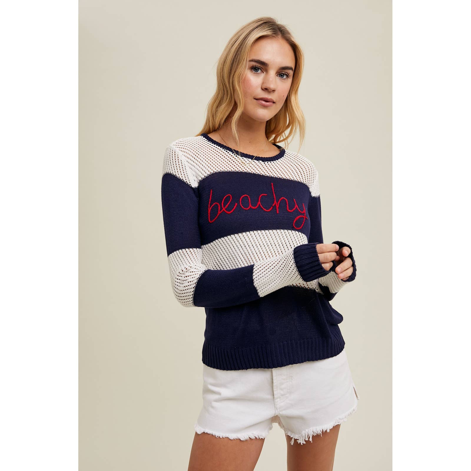 Close-up of the Wishlist Beachy Embroidered Striped Sweater Top featuring navy and white stripes with red embroidered 'Beachy' text.