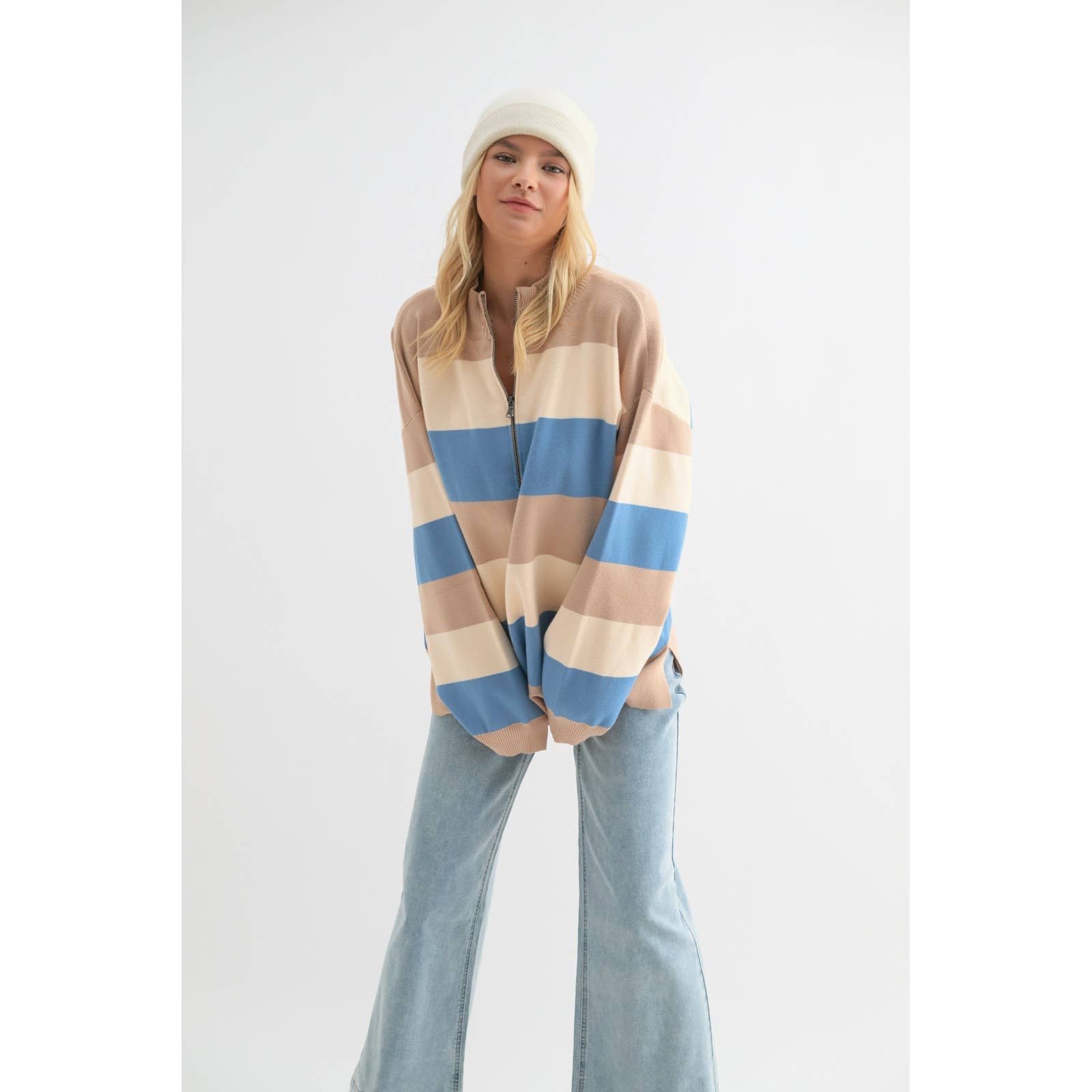 Front close-up of the Wishlist Striped Half-Zip Sweater Pullover, featuring beige, cream, and blue stripes with a relaxed fit and side slits.