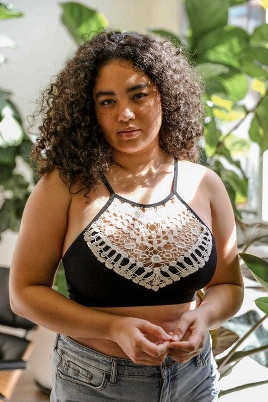 Plus-size model wearing the Black Crochet High Neck Bralette by Three Bird Nest, styled with light denim jeans for a chic boho look.