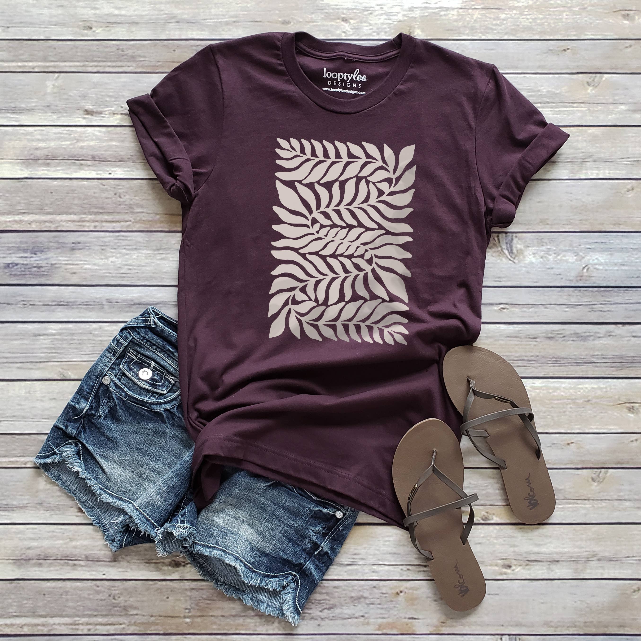 Front view of the loopty loo designs swirling vine graphic tee in the color of wine. 