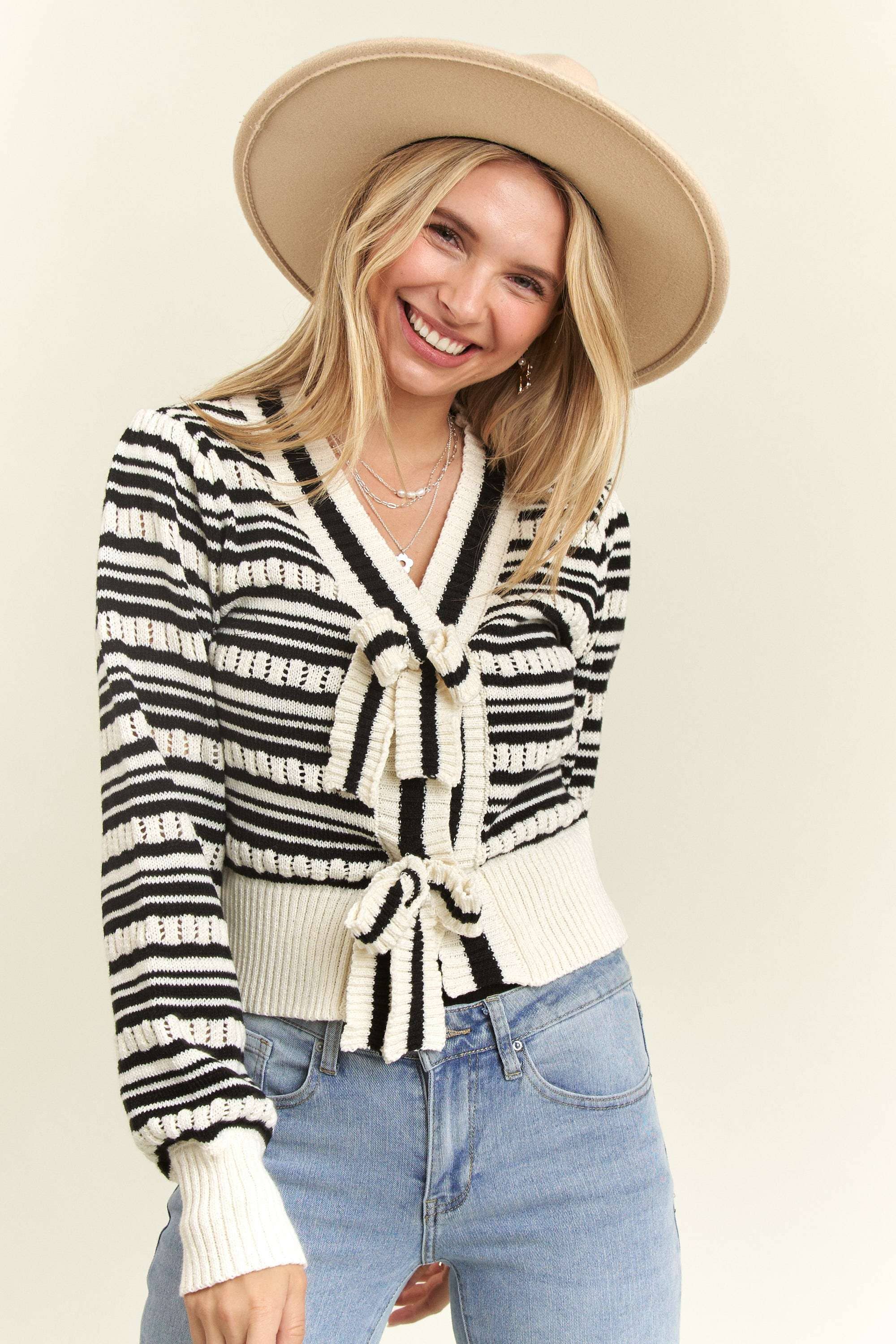 Close-up of the Madelyn Bow Tie Sweater, highlighting its bow tie detail and timeless stripe pattern.