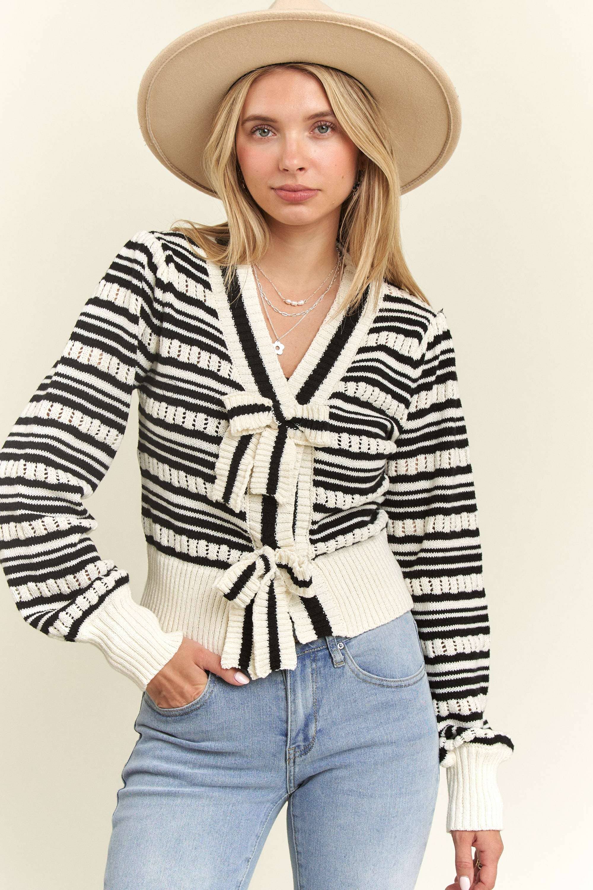 Front view of the Madelyn Bow Tie Sweater, featuring a playful bow tie detail and a lightweight striped knit design.
