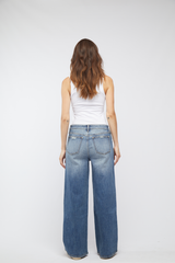 Back view of the Madison Wide Leg Mid Rise Jeans by Oliver Logan in Highway 66 wash, featuring classic back pockets and a sustainable denim design.