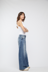 Side view of Oliver Logan’s Madison Wide Leg Mid Rise Jeans in Highway 66, showcasing the relaxed wide leg and eco-conscious denim material.