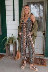Model wearing Three Bird Nest Hanging Gardens Jumpsuit styled with green fringe kimono on front porch.