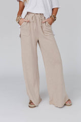 Close-up front view of Three Bird Nest Relaxing Robin Wide Leg Pant in New Taupe featuring drawstring waist and oversized pockets.