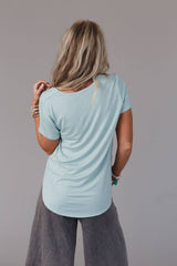 Back view of the Three Bird Nest Scoop Neck Bralette Tee in washed seafoam, highlighting the curved hem and soft texture.