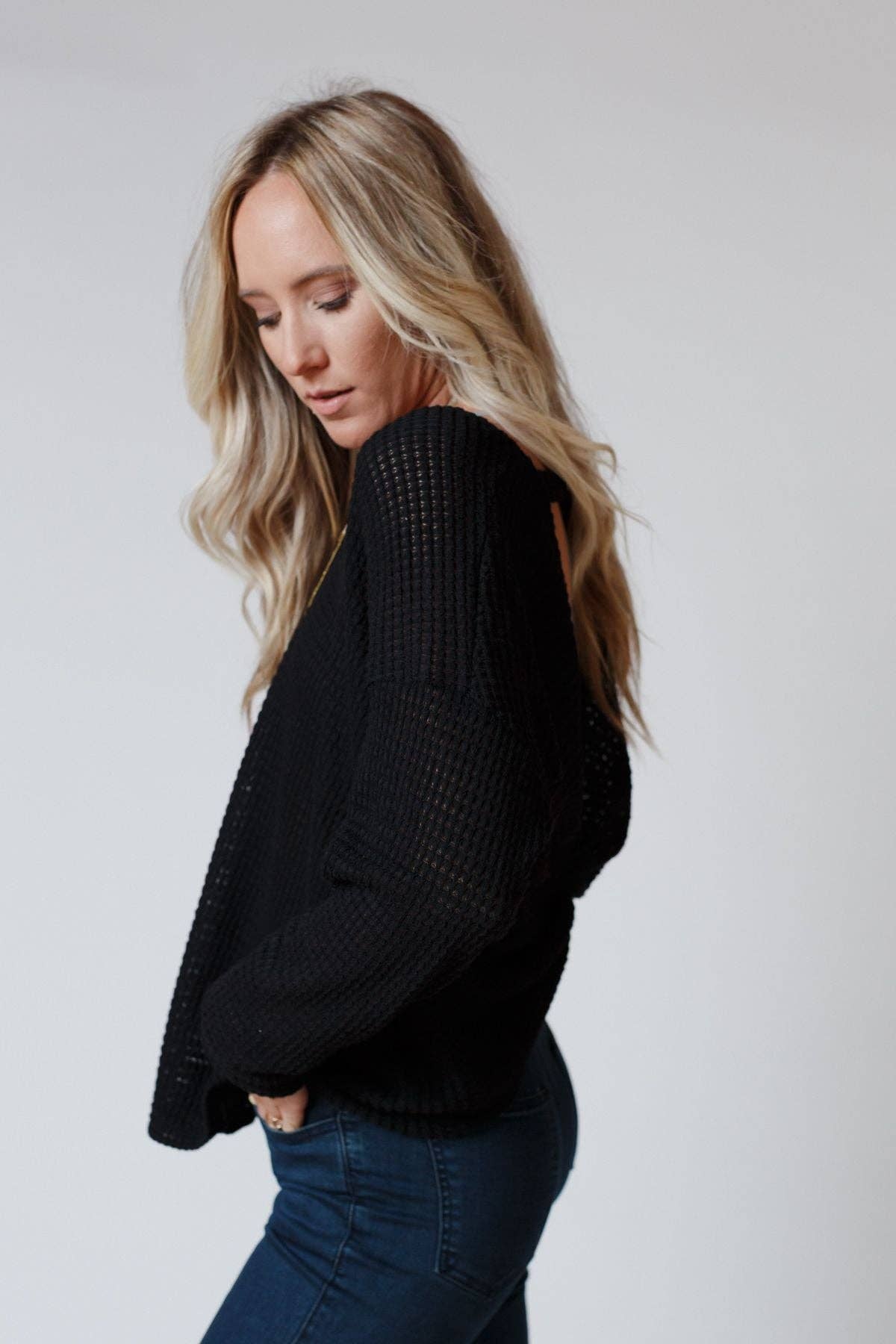 Side view of the Three Bird Nest Flattering Open Back Thermal Knit Top showcasing its cozy waffle knit fabric.