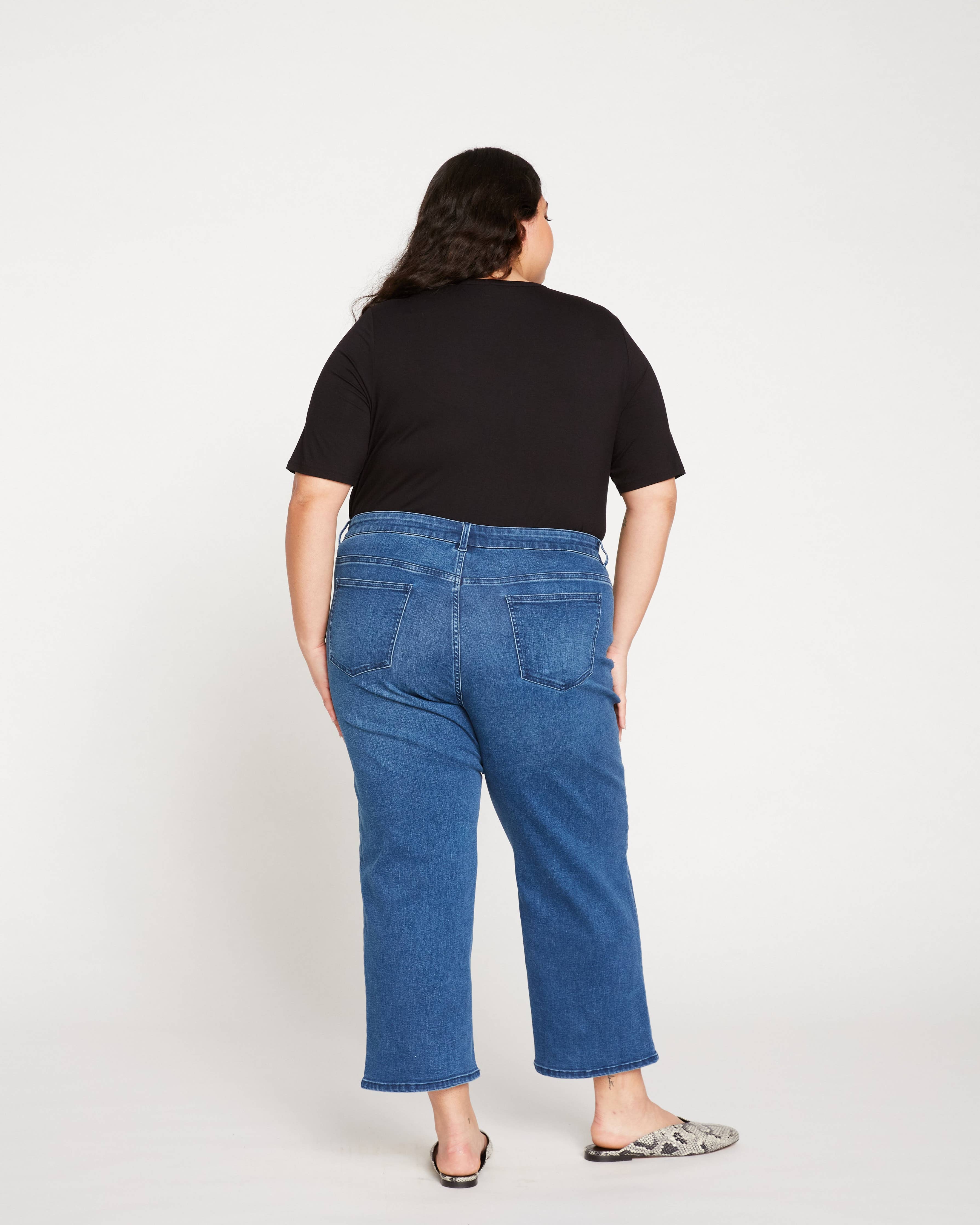 Back view of the Universal Standard Bae Boyfriend Crop Jeans in True Blue, featuring a relaxed fit and cropped length in extended plus size.