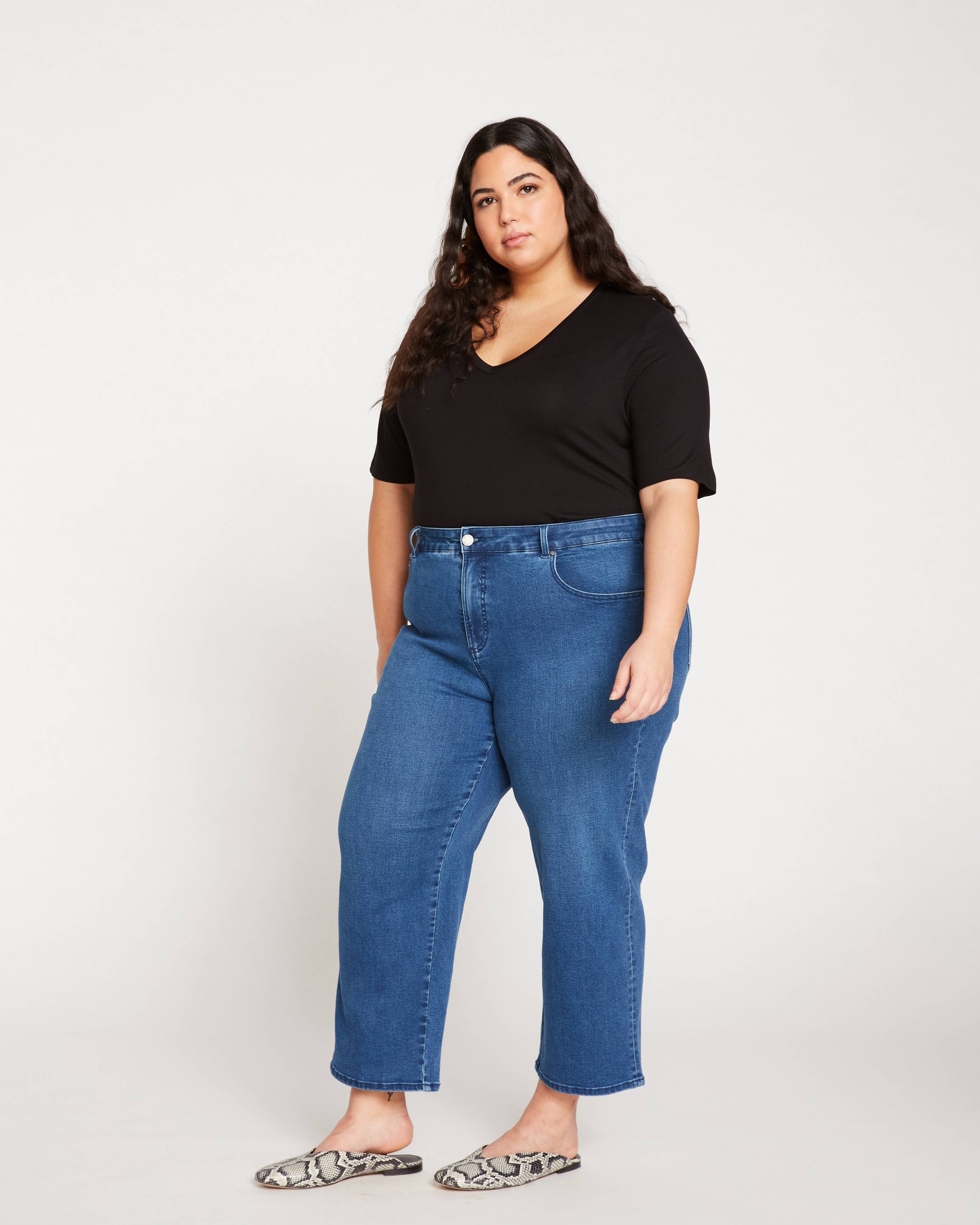 Side view of the Universal Standard Bae Boyfriend Crop Jeans in True Blue, highlighting the relaxed fit and cropped length.