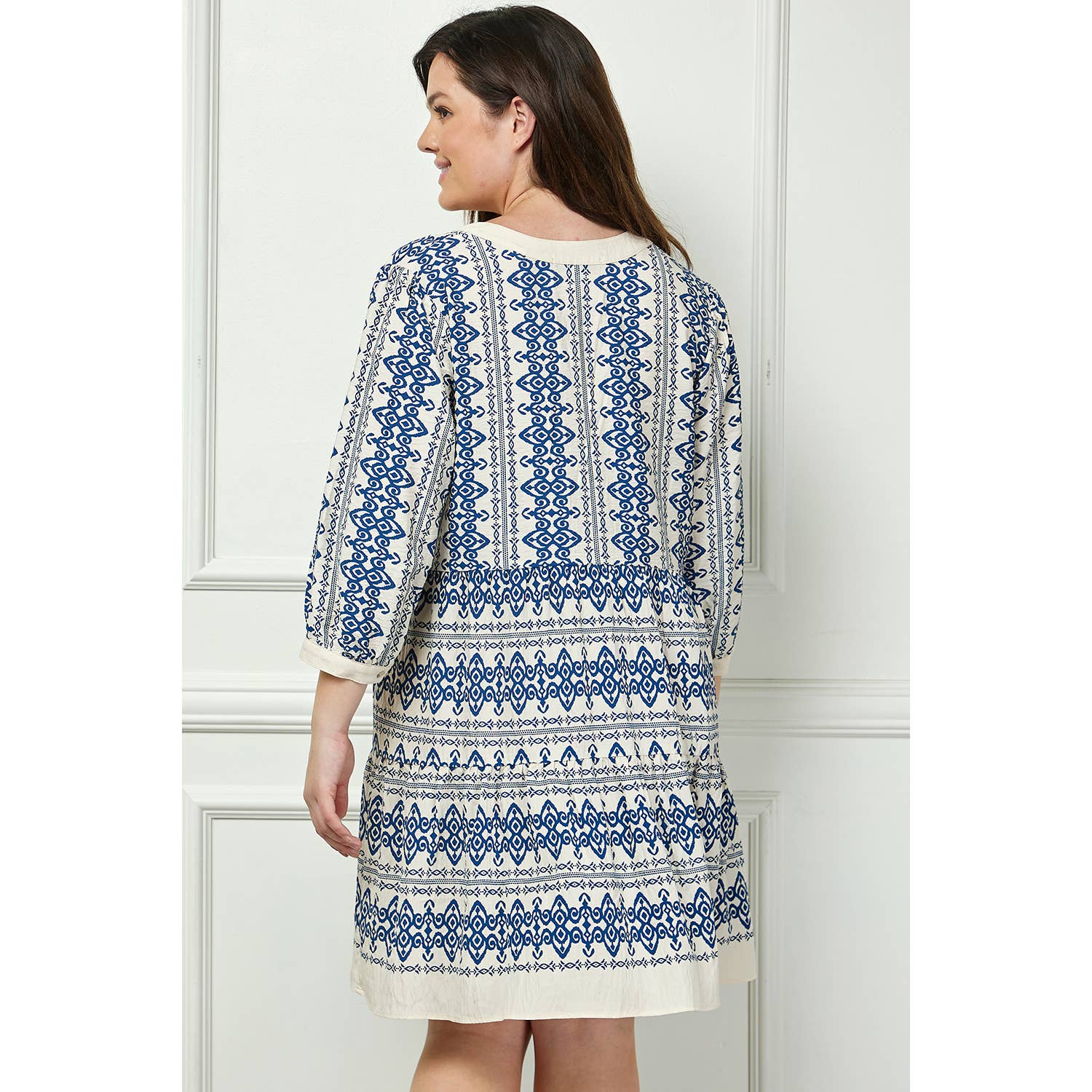 Back view of the Winslow Collection long sleeve blue and white print dress in plus size, showcasing its flowy silhouette and intricate pattern.